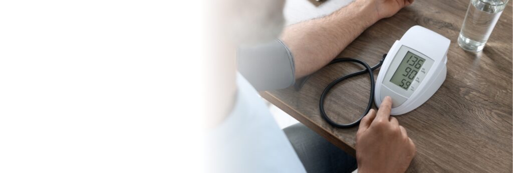 man checking his blood pressure at his table